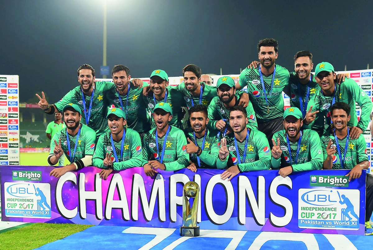 Pakistani cricketers pose for a photograph with trophy after winning the third and final Twenty20 International match against World XI at the Gaddafi Cricket Stadium in Lahore, yesterday. 