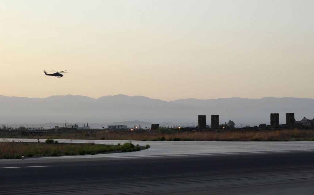 A picture taken during a press tour provided by the Russian Armed Forces on September 12, 2017 shows a Russian Kamov helicopter flies near S-300 missile system at the Hmeimim military base in Latakia province, in the northwest of Syria. / AFP / Maria ANTO