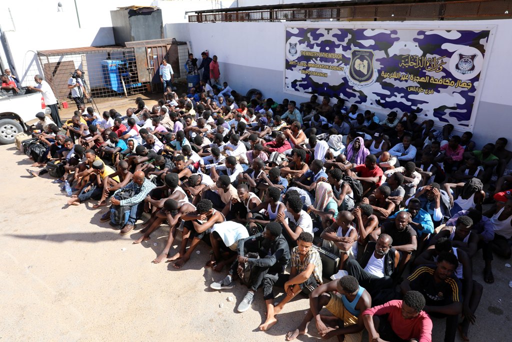 Sudanese migrants sit at a detention center before their voluntary return to their country, in Tripoli, Libya September 14, 2017. REUTERS/Hani Amara

