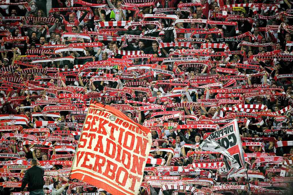 Cologne's supporters cheer their team during the German first division Bundesliga football match Borussia Dortmund v FC Cologne in Dortmund, western Germany, on September 17, 2017.  AFP / SASCHA SCHUERMANN