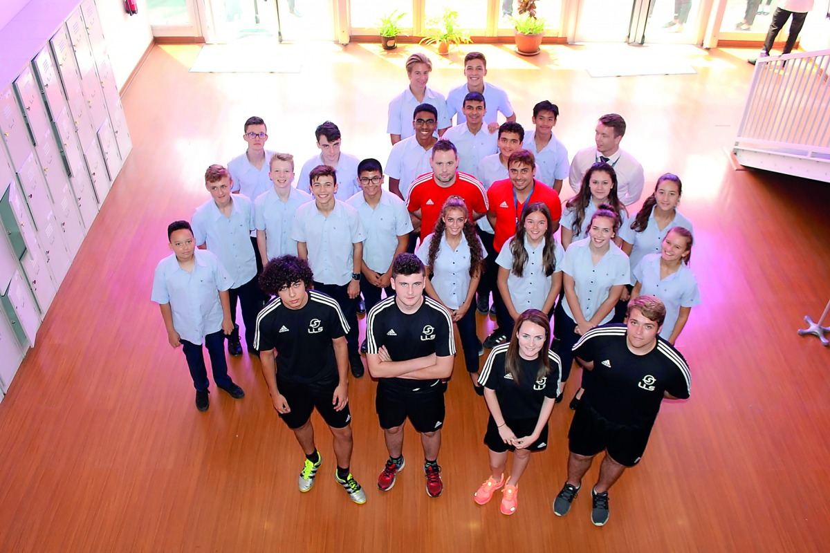 Michael Beale, the newly appointed Foundation Phase coach at Liverpool FC and Little League Sports’ (LLS) Ambassador,   poses for a photograph with students and officials of Doha College and Evolution Sports.
