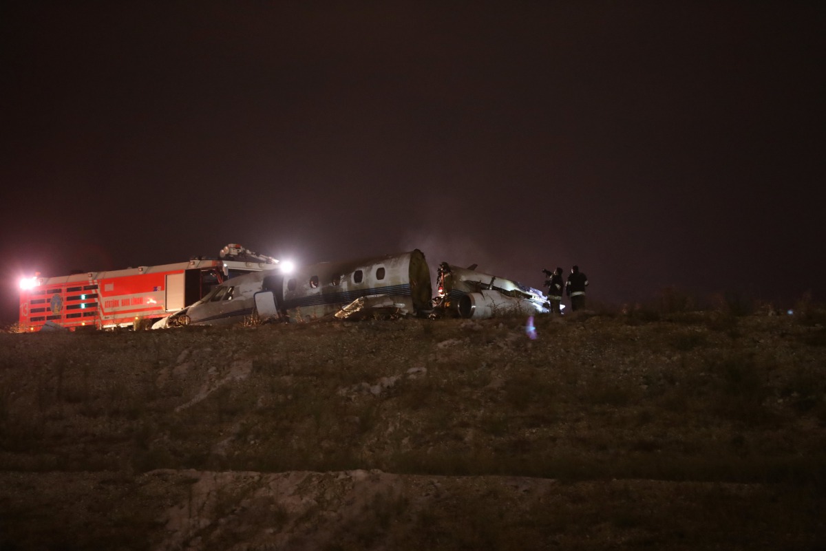 Firefigters stand next to the wreckage of a private jet after it crashed at Ataturk airport in Istanbul, Turkey, September 21, 2017. Reuters/Osman Orsal