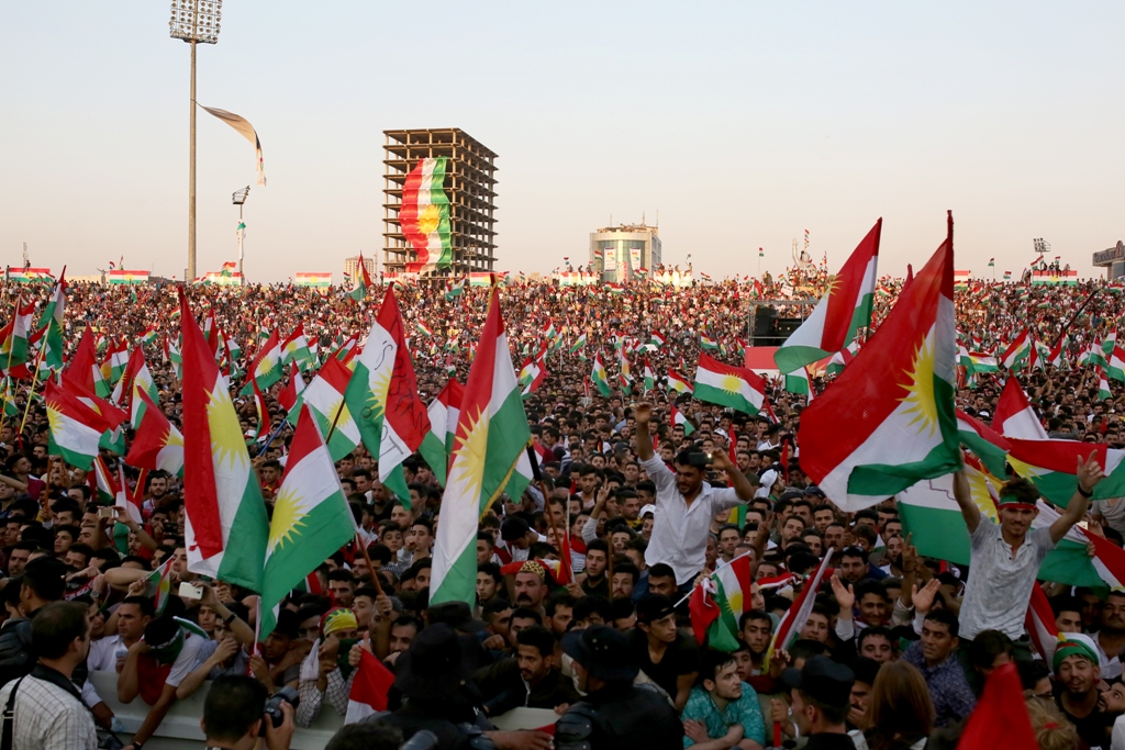 People gather to listen President of Iraqi Kurdish Regional Government (IKRG) Masoud Barzani's speech as they hold IKRG flags during a campaign ahead of next week's so-called referendum on regional independence in Erbil, Iraq on September 22, 2017.  Yunus