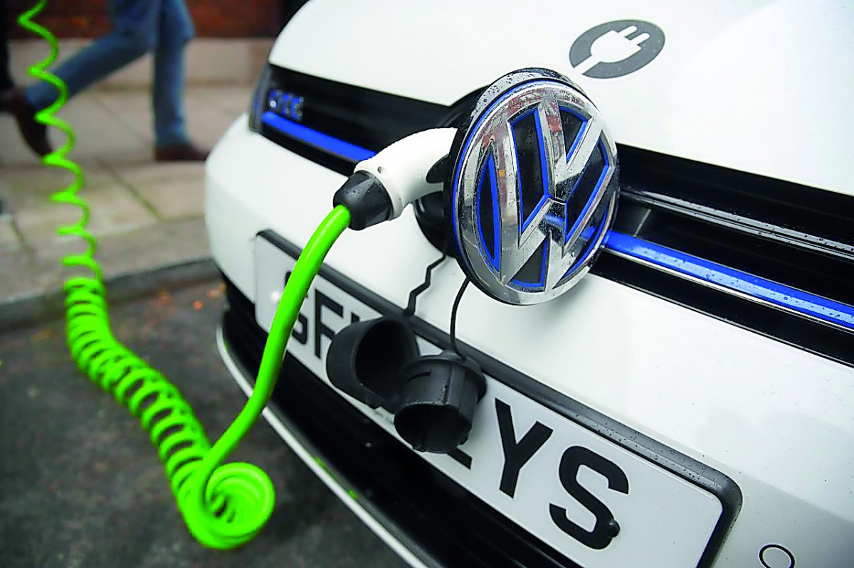 A file picture of an electric Volkswagen car plugged into a recharging point in central London.

