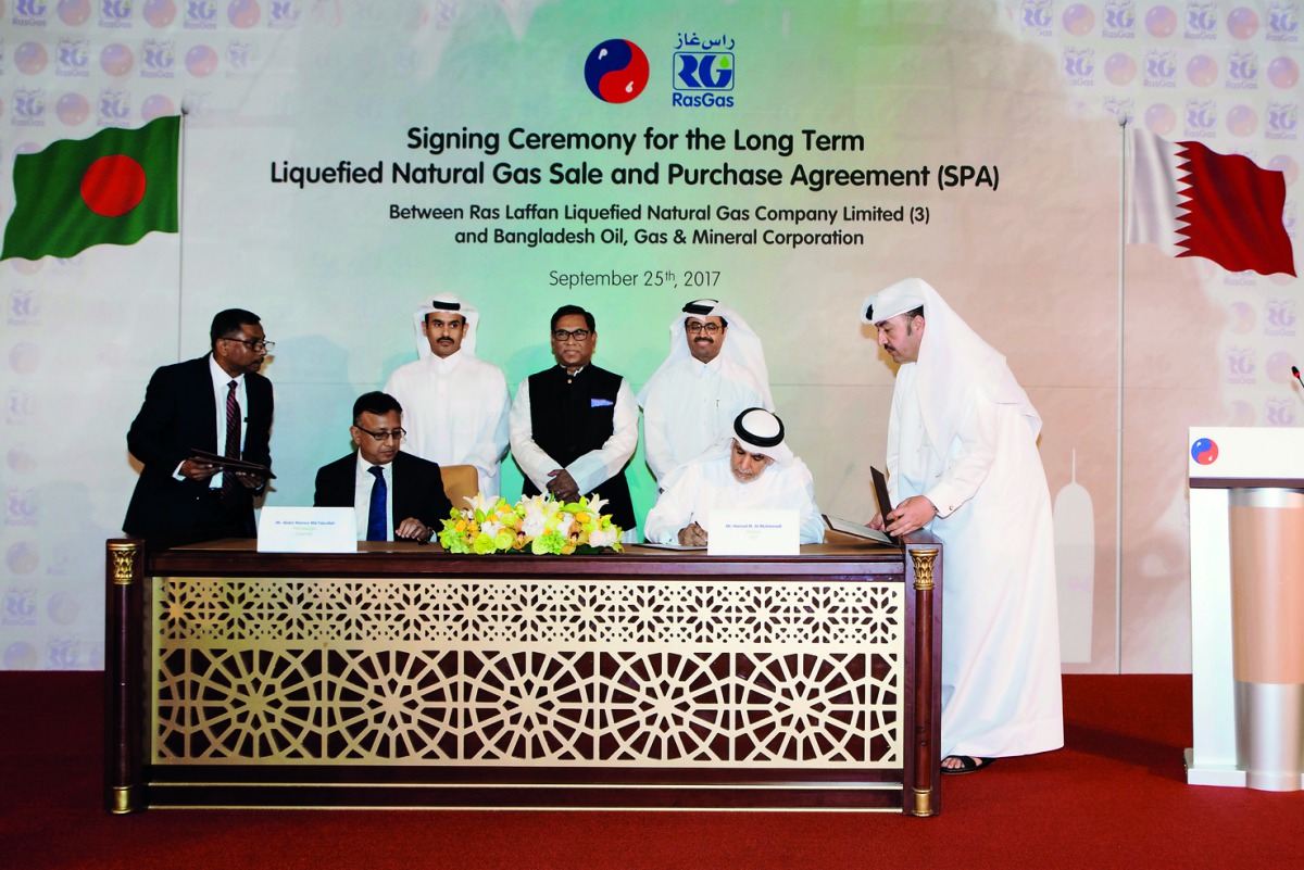 H E Dr Mohammed bin Saleh Al Sada (standing right), Minister of Energy and Industry; Nasrul Hamid (standing centre) Bangladesh State Minister; Saad Sherida Al Kaabi (standing left), Qatar Petroleum President and CEO, witness Hamad Mubarak Al Muhannadi (si