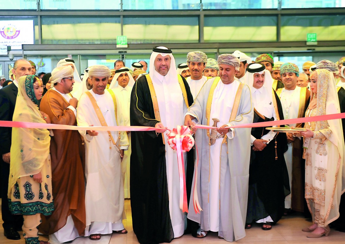 H E Sheikh Ahmed bin Jassim Al Thani (centre), Minister of Economy and Commerce and H E Dr Ali bin Masoud bin Ali Al Sunaidy (right), Minister of Commerce and Industry of Oman, cutting the ribbon to mark the opening of Omani Products Exhibition (OPEX) at 