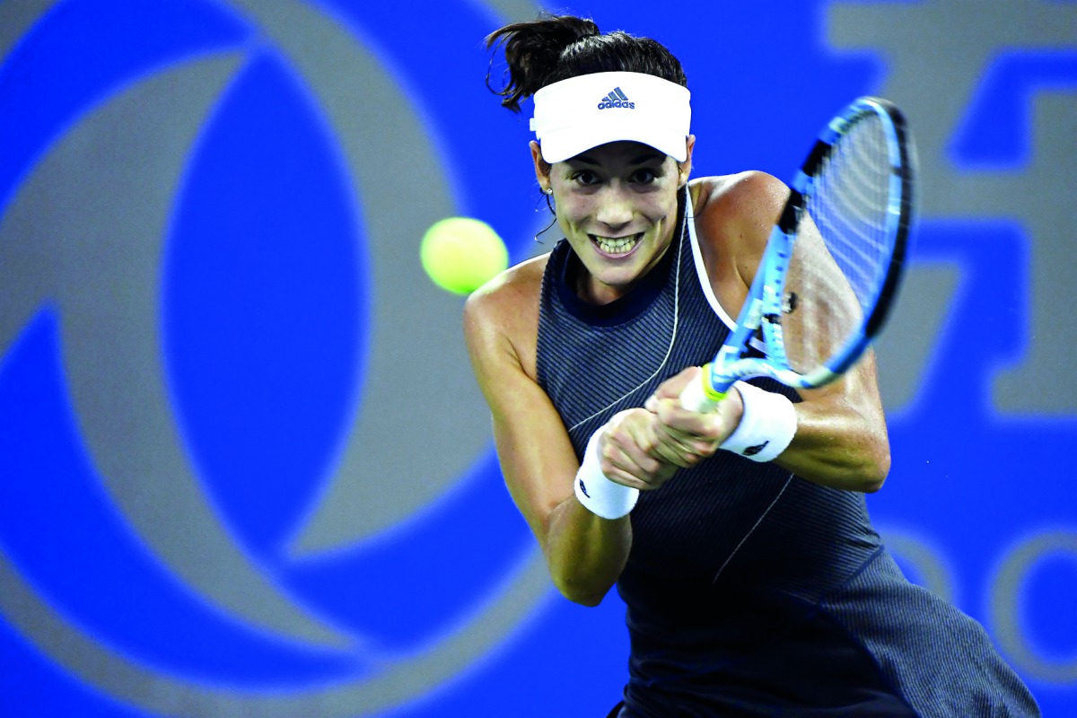Garbine Muguruza of Spain hits a return against Lesia Tsurenko of Ukraine during their second round women’s singles match at the WTA Wuhan Open in Wuhan, China yesterday.
