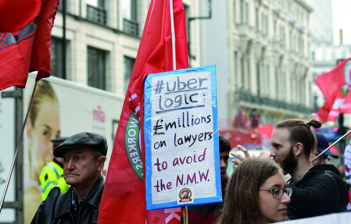 People take part in a protest against Uber and in favour of labour rights in central London, Britain, September 27, 2017. REUTERS/Mary Turner
