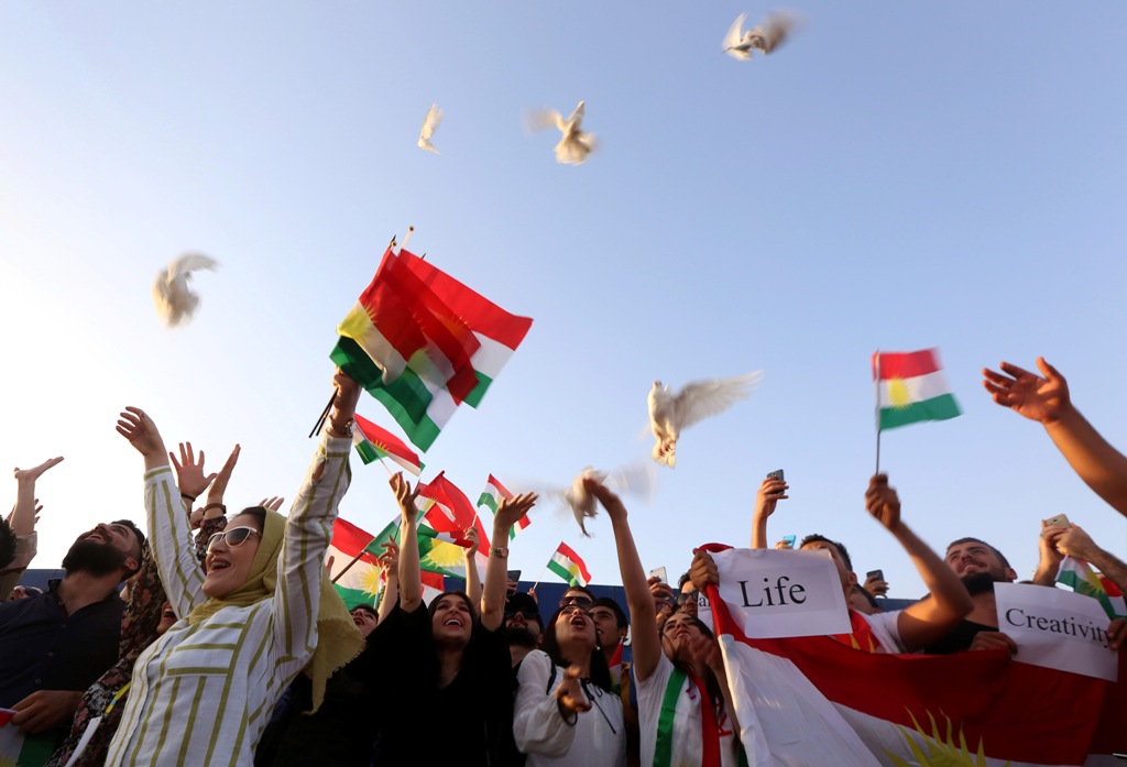 Iraqi Kurds release doves during in a demonstration at Arbil airport, in the capital of Iraq's autonomous northern Kurdish region, after the central government ordered the indefinite halt to all foreign flights to and from Iraqi Kurdistan on September 29,
