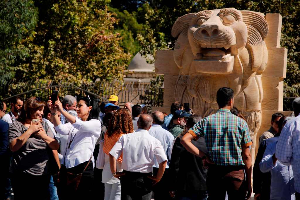 The General Directorate of Antiquities and Museums in Syria present the statue of the Lion of Al-Lat, which dates back to the first century AD, to the public after its restoration at the National Museum in Damascus on October 1, 2017.   AFP / LOUAI BESHAR