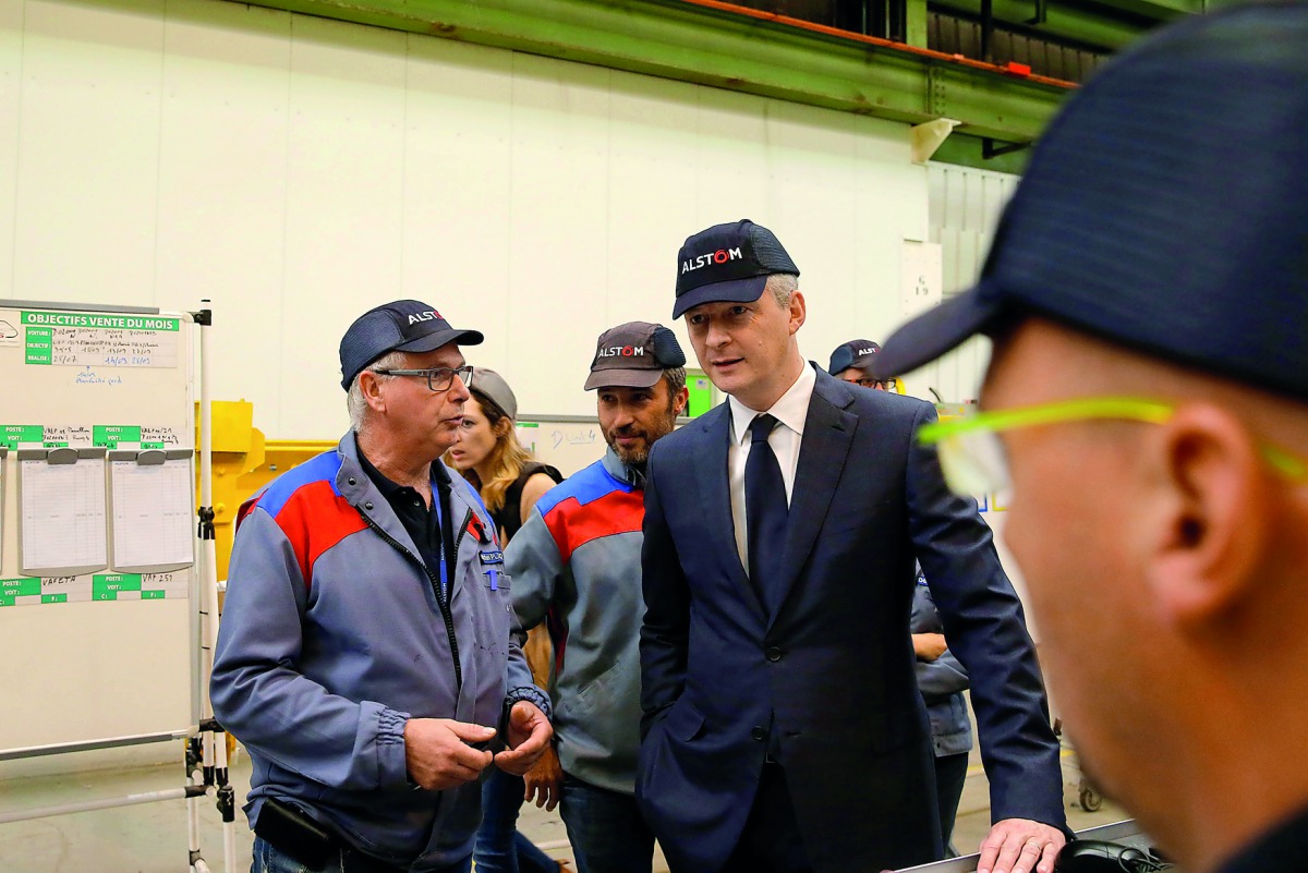 French Finance Minister Bruno Le Maire (C) talks with employees during a visit at the Alstom plant in Petite-Foret near Valenciennes, France, September 29, 2017. REUTERS/Pascal Rossignol