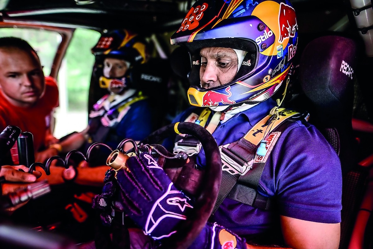 Al Attiyah (right) with French navigator Matthieu Baumel (centre).