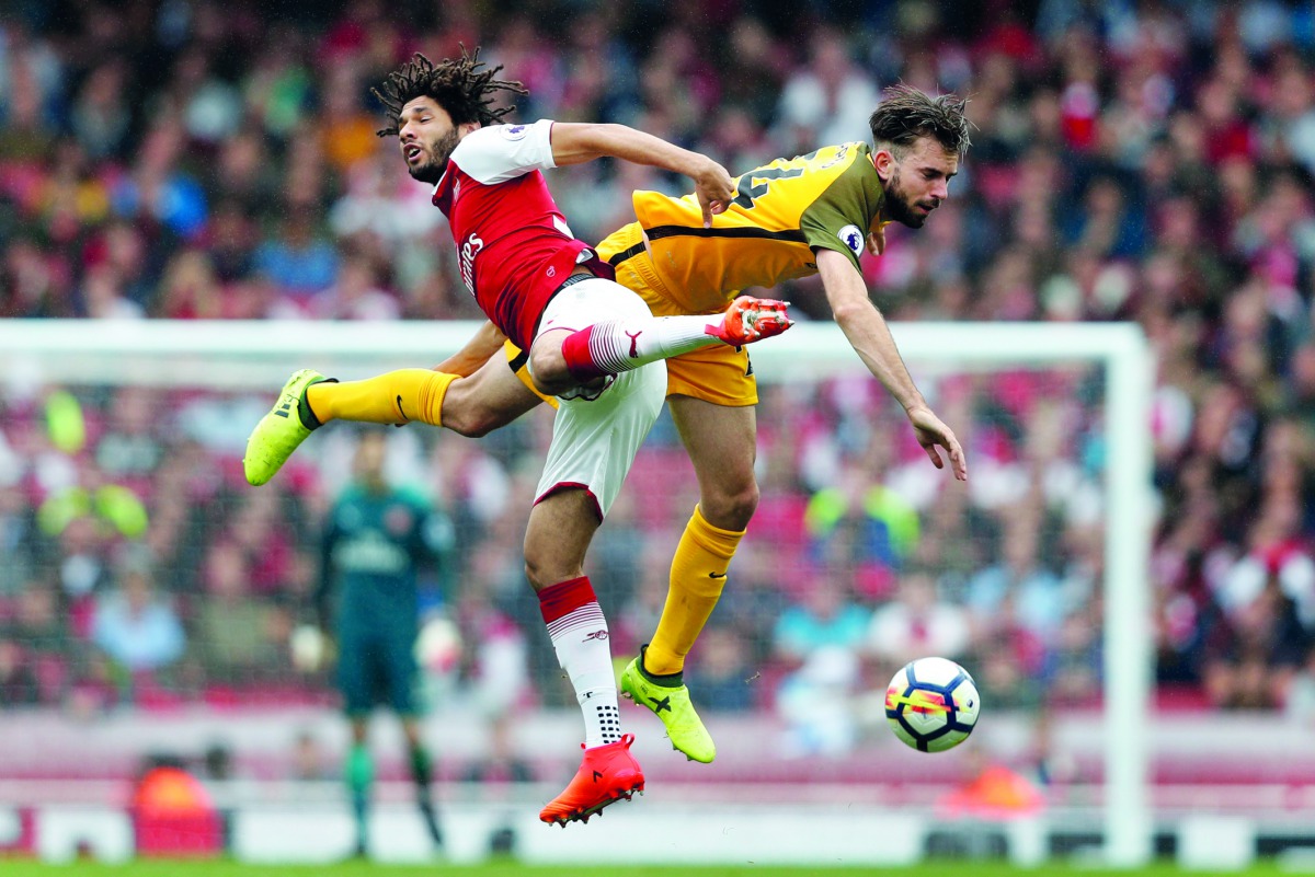 Arsenal midfielder Mohamed Elneny (left) vies with Brighton’s midfielder Davy Propper during the English Premier League match at the Emirates Stadium in London, yesterday.