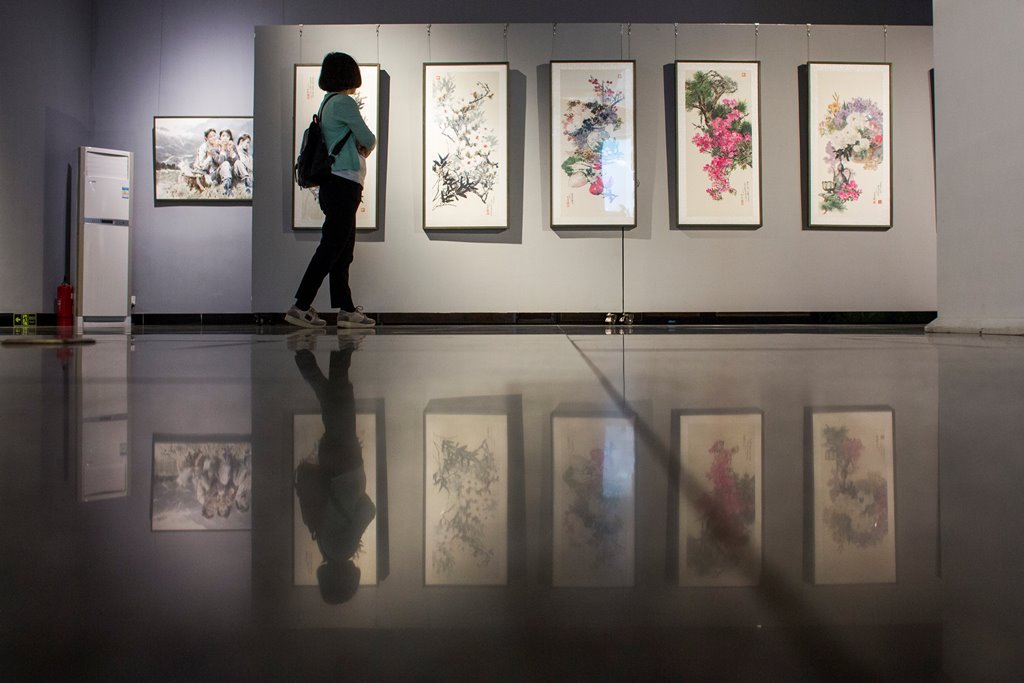 A visitor looks at works by North Korean artists at the Mansudae Art Museum in the 798 art district in Beijing, China, September 20, 2017. Thomas Peter / REUTERS
