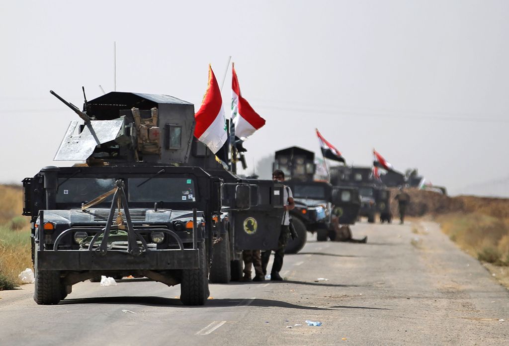 Vehicles of the Iraqi forces and Hashed al-Shaabi (Popular Mobilisation) paramilitaries are seen on the advance towards the Islamic State (IS) group's stronghold of Hawija on October 3, 2017, to recapture the town from the jihadists. Iraqi forces on Septe
