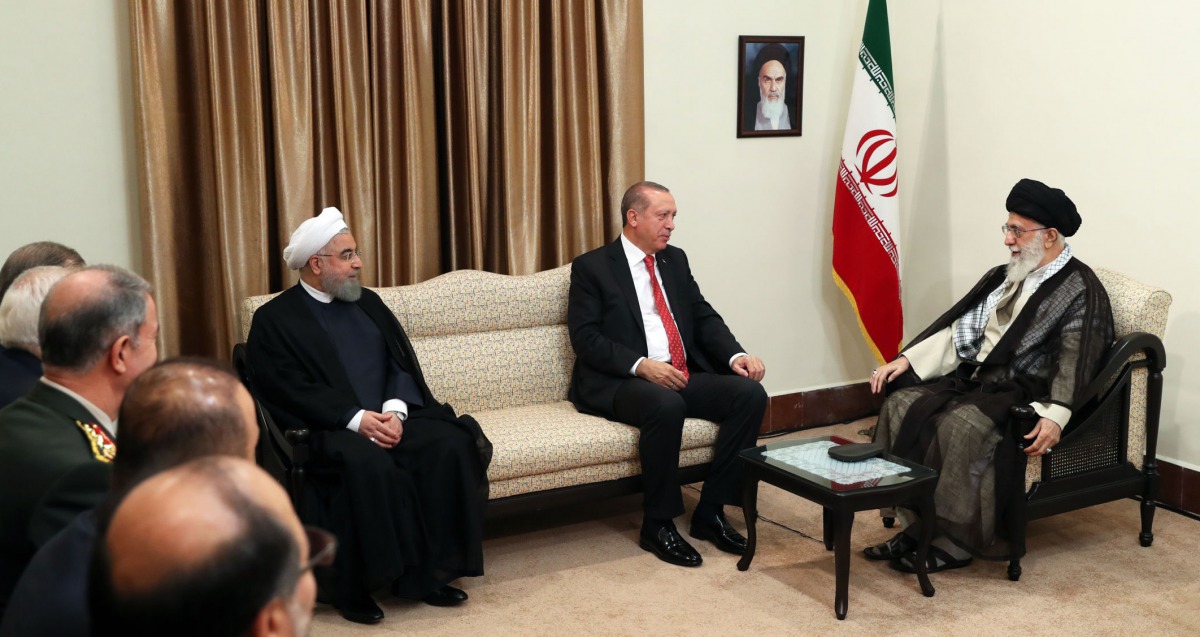 A handout photo provided by the office of Iran's supreme leader Ayatollah Ali Khamenei shows him (R) and President Hassan Rouhani (L) meeting with Turkish President Recep Tayyip Erdogan in Tehran on October 4, 2017.  AFP / Iranian Supreme Leader's Website