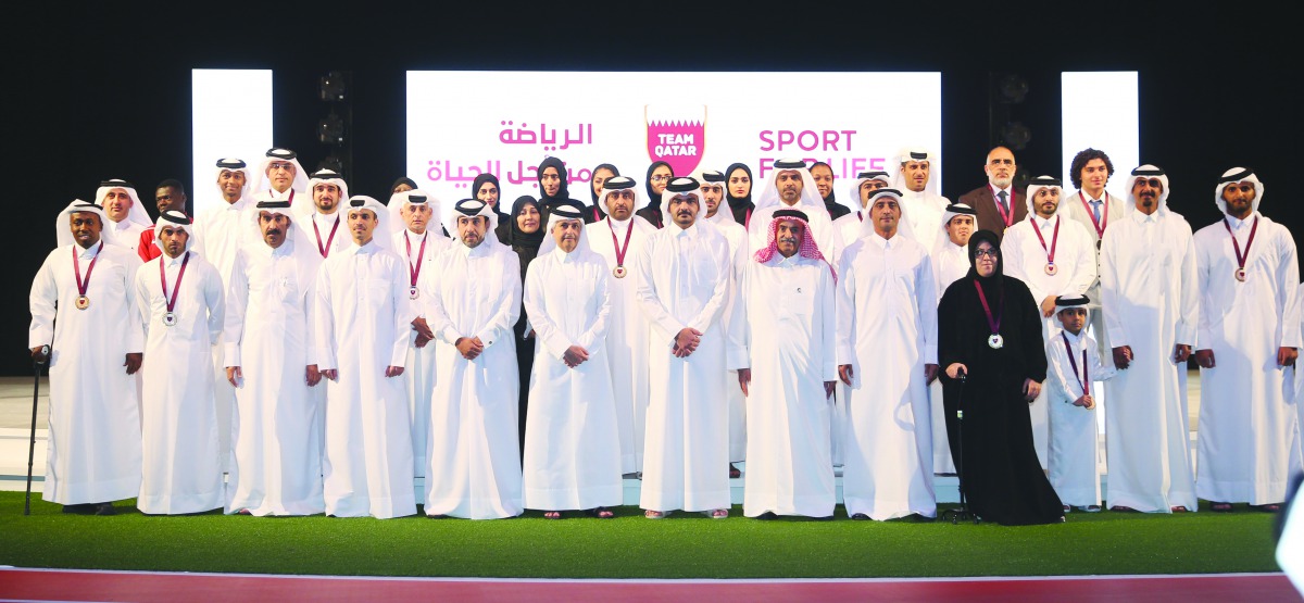 Winners of the annual Sport Excellence Awards pose for a photograph with Qatar Olympic Committee (QOC) President H E Sheikh Joaan bin Hamad Al Thani and officials of QOC and sport associations at the Qatar National Convention Centre yesterday. Pictures: M