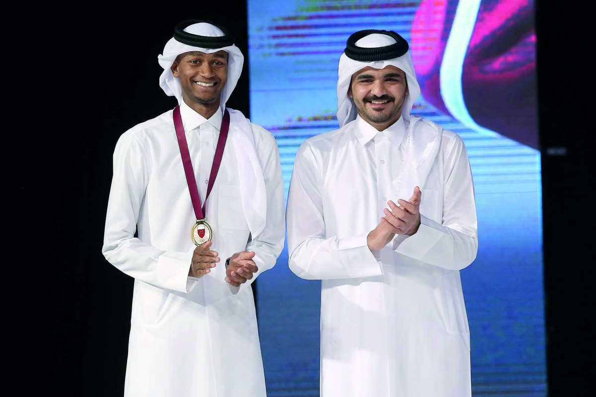 QOC Chairman H E Sheikh Joaan bin Hamad Al Thani (right) and Male Athlete of the Season and world champion Mutaz Essa Barshim pose for a photograph yesterday.