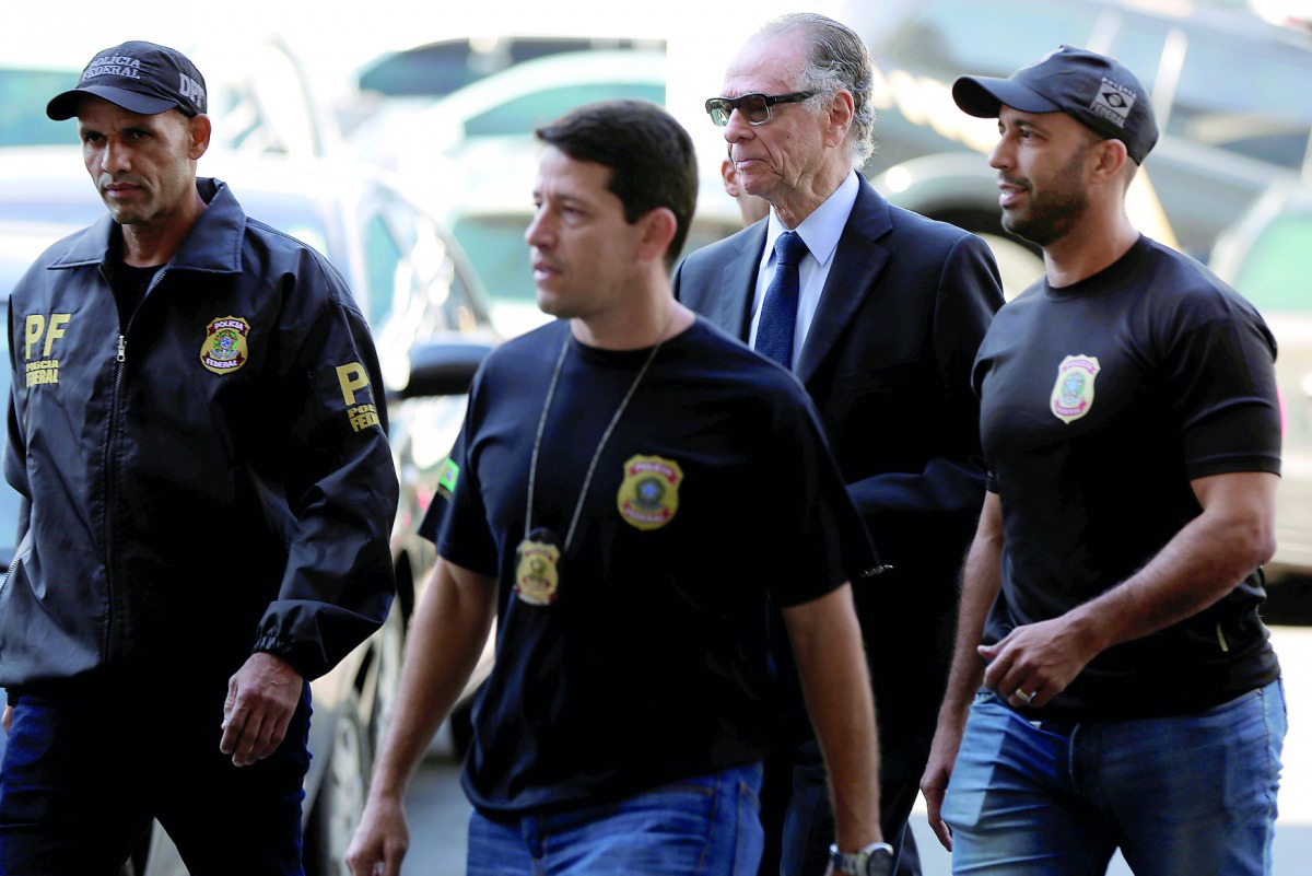 Brazilian Olympic Committee (COB) President Carlos Arthur Nuzman (centre) arrives to Federal Police headquarters in Rio de Janeiro, Brazil yesterday.