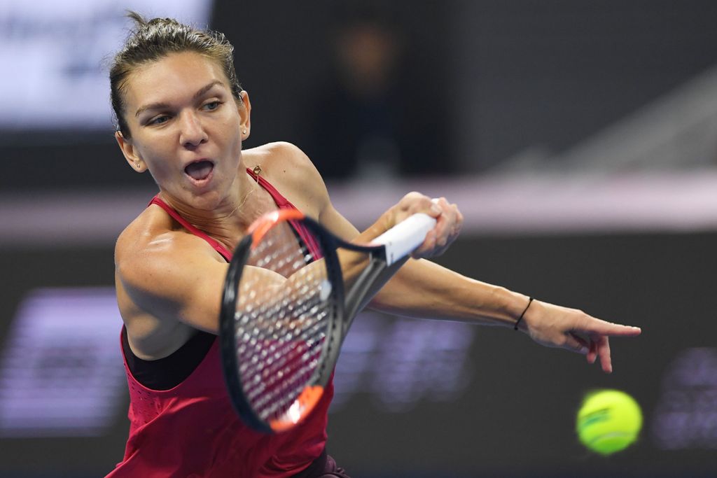 Simona Halep of Romania hits a return during the women's singles final against Caroline Garcia of France at the China Open tennis tournament in Beijing on October 8, 2017. / AFP / GREG BAKER