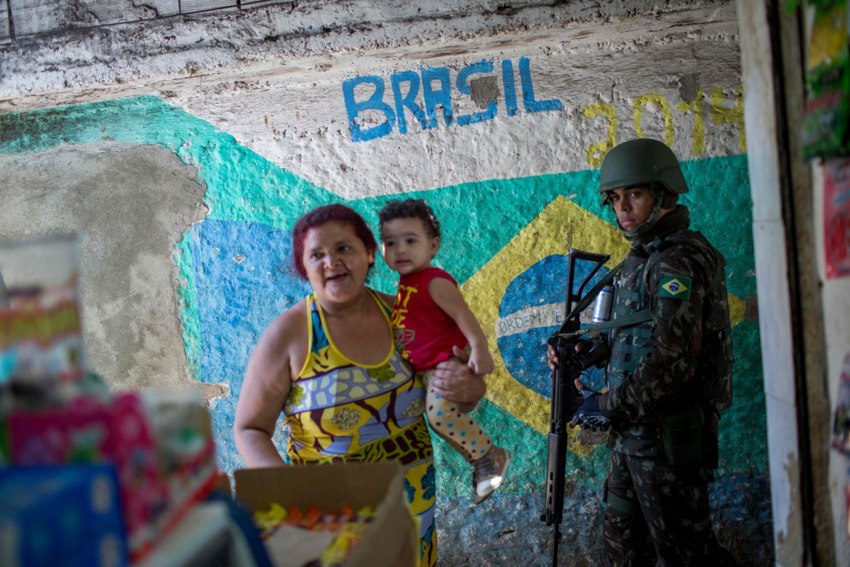 Brazilian army soldiers patrol the Rocinha favela in Rio de Janeiro, Brazil on October 11, 2017. Some 500 soldiers, some in armored vehicles, swept into Rio de Janeiro's Rocinha favela Tuesday to support a police raid after gun fights broke out between ri