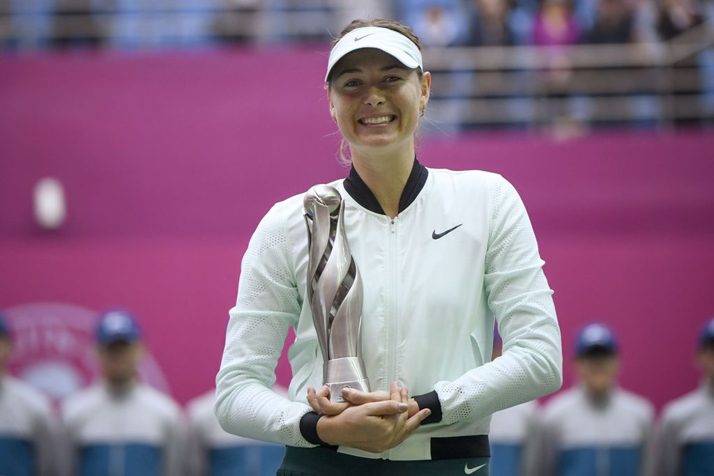 Maria Sharapova of Russia holds her trophy after winning her women's singles final match against Aryna Sabalenka of Belarus at the Tianjin Open tennis tournament in Tianjin on October 15, 2017. / AFP / WANG Zhao
