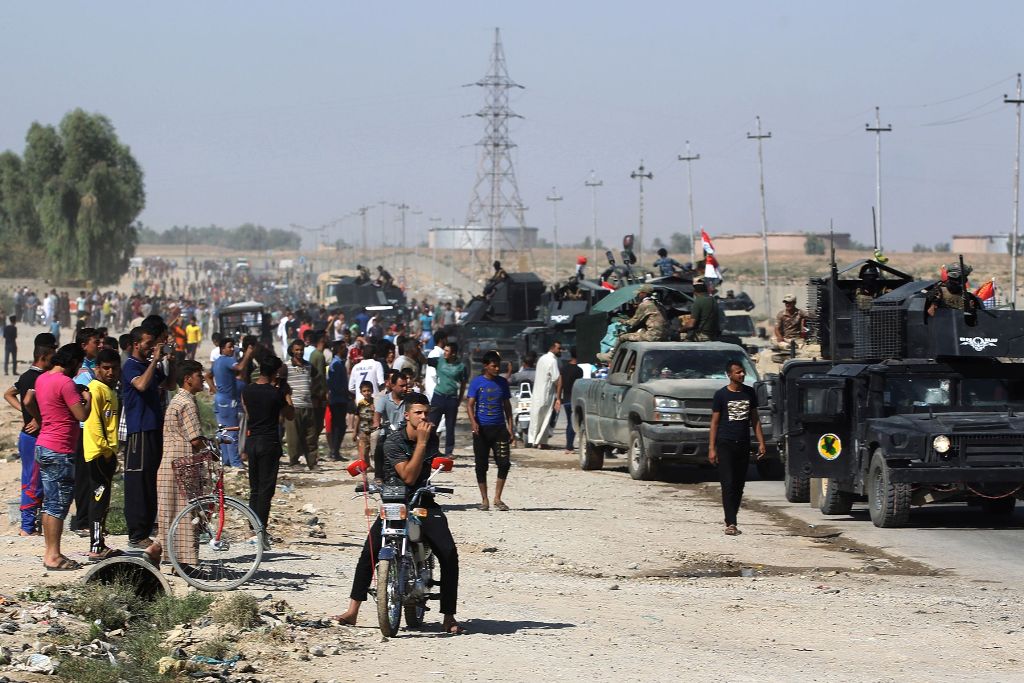 Iraqis gather as Iraqi forces arrive in the first neighbourhood on the southern outskirts of Kirkuk on October 16, 2017.  AFP / AHMAD AL-RUBAYE

