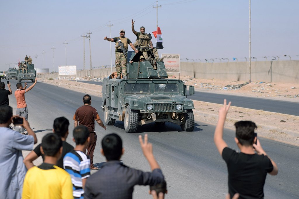 People gather on the road as they welcome Iraqi security forces members, who continue to advance in military vehicles in Kirkuk, Iraq October 16, 2017. REUTERS/Stringer