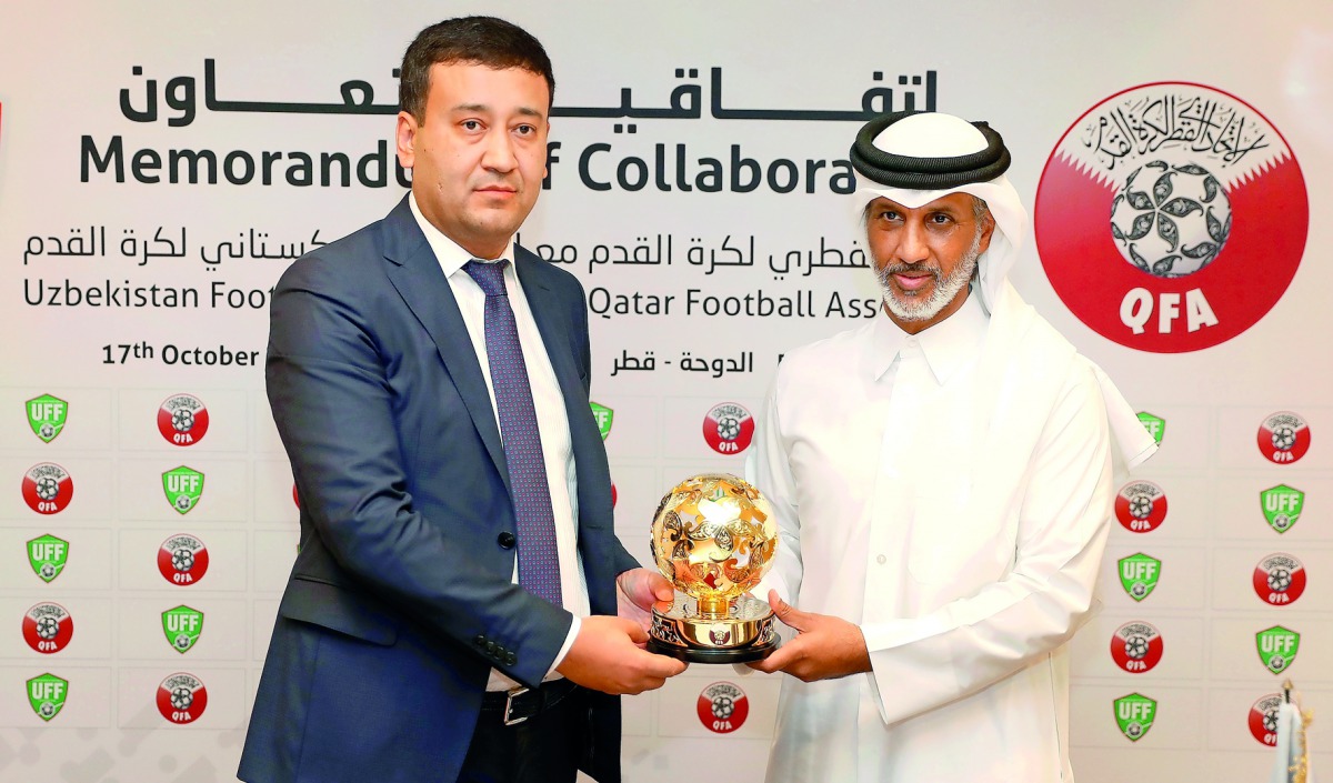 Sheikh Hamad bin Khalifa bin Ahmed Al Thani, President of Qatar Football Association (QFA) hands over a memento to Umid Ahmadjonov, President of Uzbekistan Football Federation (UFF) after signing a memorandum of collaboration at QFA’s headquarters at Al B