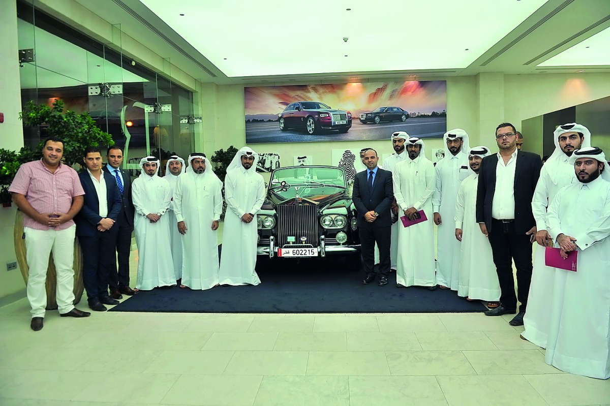 Abdul Hameed Al Siddiqi (last left), renowned Qatari artist  and senior officials of Rolls-Royce Motor Cars Doha, along with customers during the ‘Qatar Icon’ Art Exhibition which was held at the car showroom in The Pearl, yesterday. Pic Baher Amin/ The P