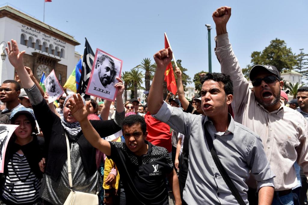 Protesters shout slogans during a demonstration against corruption and official abuses, in the Rif region in Rabat, Morocco June 11, 2017. On left is a portrait of protest movement leader Nasser Zefzafi. REUTERS/Stringer