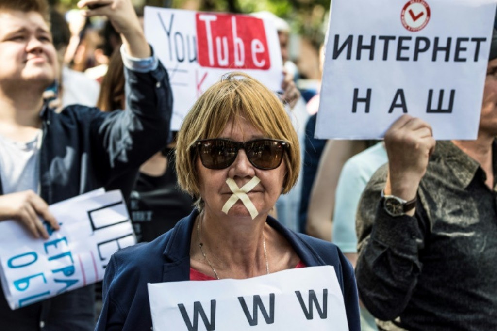A file photo of a protester with tape covering her mouth takes part in the March for Free Internet in central Moscow in July. AFP / Mladen ANTONOV