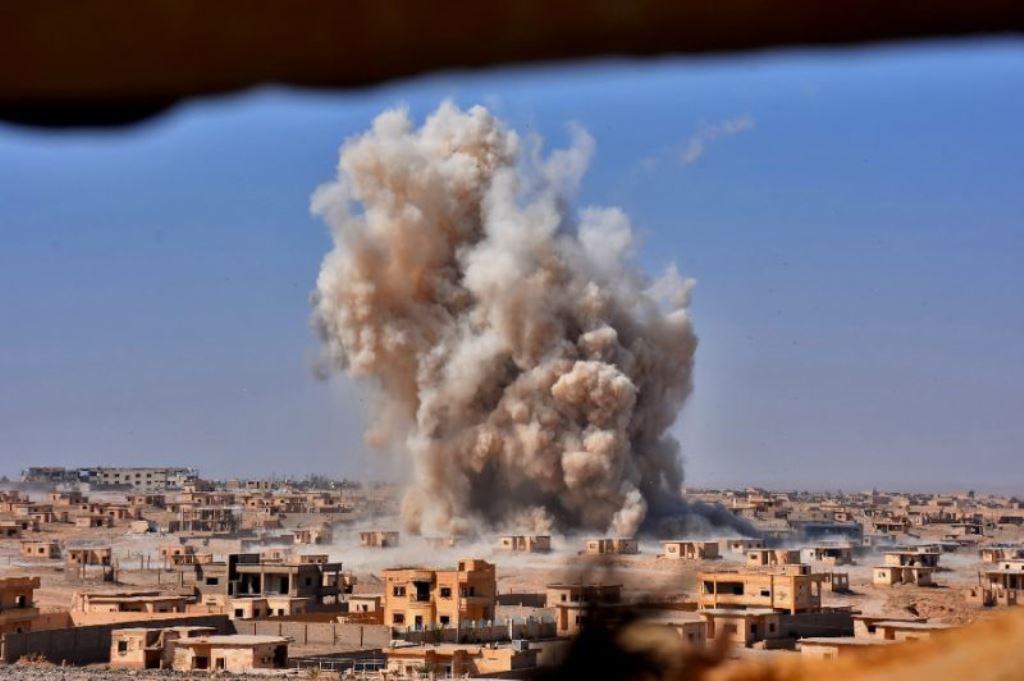 File photo of smoke rising from buildings in Deir Ezzor. Reuters 