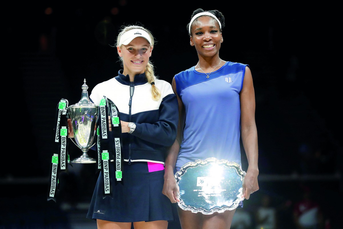 Denmark’s Caroline Wozniacki celebrates with the trophy after winning the final against USA’s Venus Williams in Singapore yesterday.