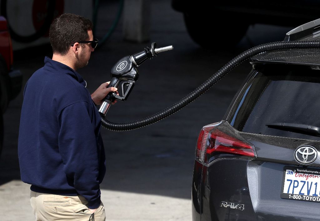 (FILES) This file photo taken on May 09, 2017 shows a customer preparing to pump gasoline into his car at a gas station in San Anselmo, California.  AFP  / JUSTIN SULLIVAN