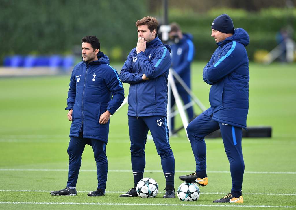 A file photo of Tottenham Hotspur's Argentinian head coach Mauricio Pochettino (C) stands with assistant manager Jesus Perez (L) during a training session at Tottenham Hotspur's Enfield Training Centre, on October 31, 2017 on the eve of their UEFA Champio