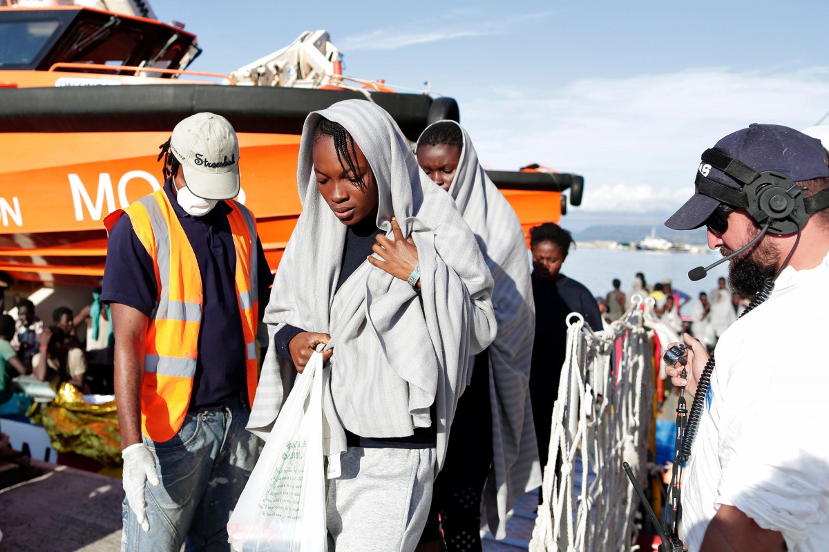FILE PHOTO: This handout picture taken and released by the Italian Red Cross on October 22, 2016 shows migrants landing in Vibo Marina, after a rescue operation in the Mediterranean Sea (AFP) 