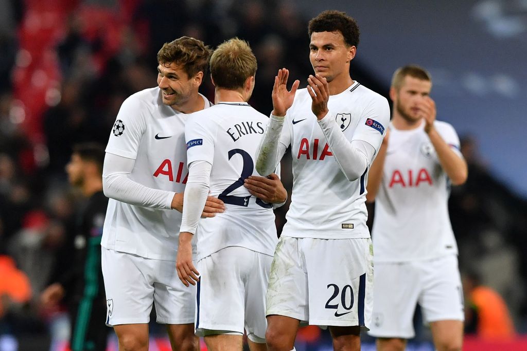 Tottenham Hotspur's English midfielder Dele Alli (2nd R) and teammates celebrate their win on the pitch after the UEFA Champions League Group H football match between Tottenham Hotspur and Real Madrid at Wembley Stadium in London, on November 1, 2017. Tot