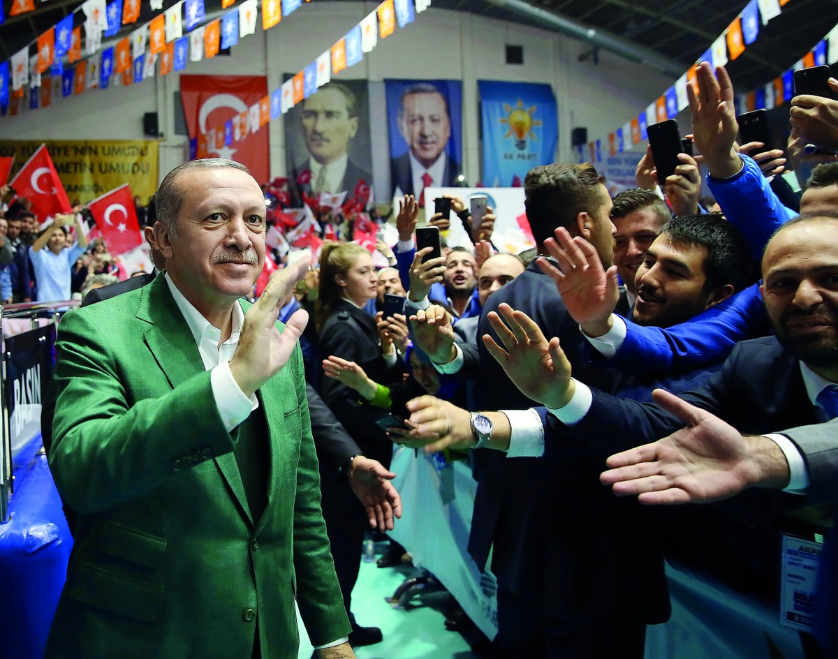 Turkish President Recep Tayyip Erdogan (L) greets people as he attends the provincial meeting of Justice and Development (AK) Party in Manisa, Turkey on November 03, 2017. (Turkish Presidency / Yasin Bulbul / Handout - Anadolu Agency )