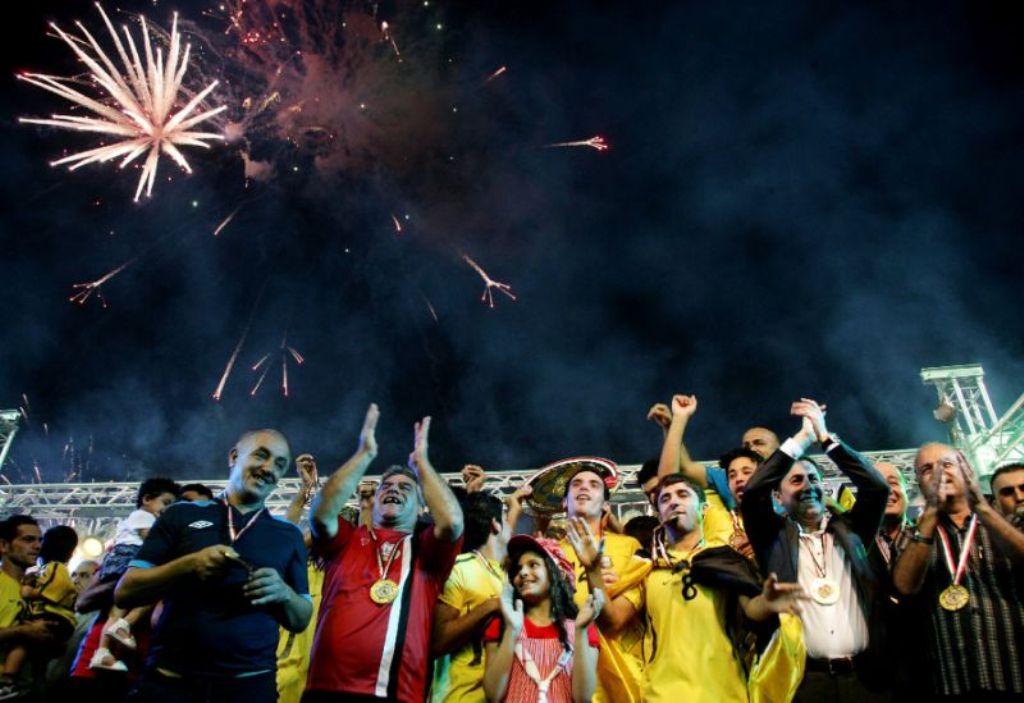 Fans from Arbil football club celebrate winning the Iraqi league in 2012, but now the team could be sidelined as the crisis between Baghdad and Kurdistan spills over into sports. / AFP.