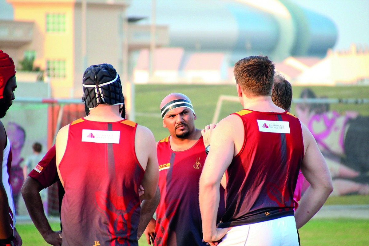 Joe Dharshan Goonethillaka (centre), from Doha Maroon, discusses team tactics ahead of the game against Blue Phoenix.