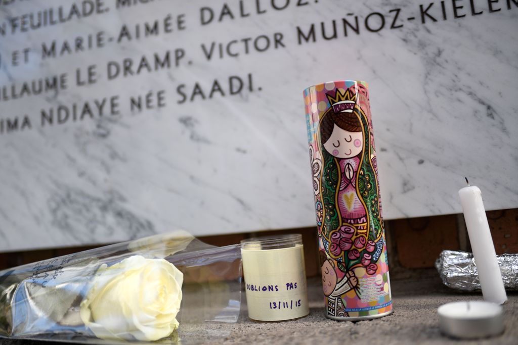 Flowers and candles are left in front of a plaque for victims of a shooting at La Belle Equipe cafe - restaurant during ceremonies across Paris marking the second anniversary of the terror attacks of November 2015 in which 130 people were killed, in the F
