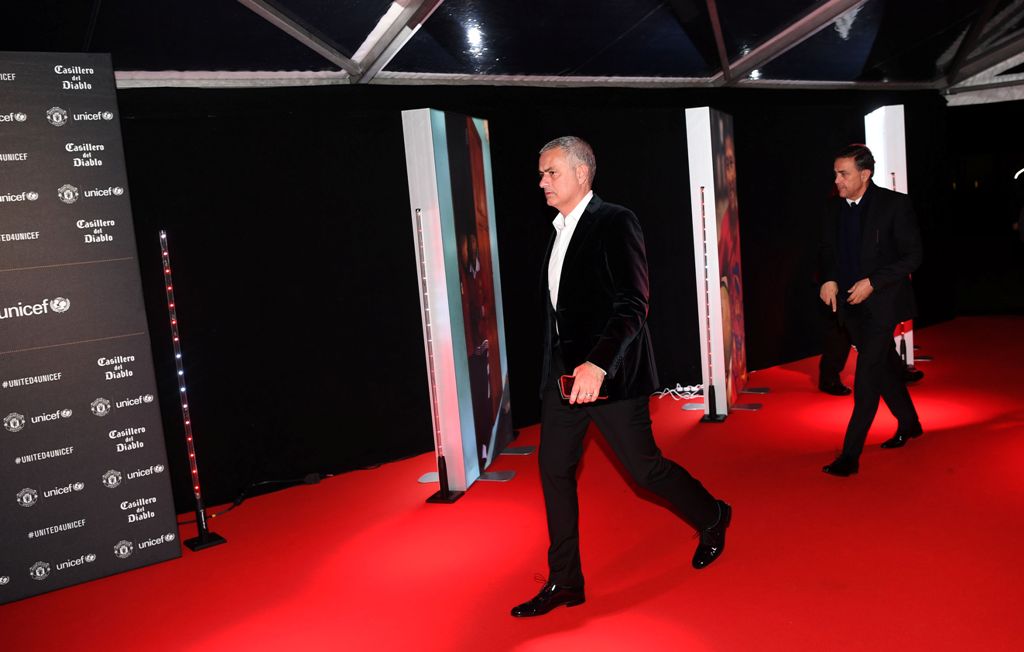 Manchester United's Portuguese manager Jose Mourinho (L) walks on the red carpet as he arrives to attend the 