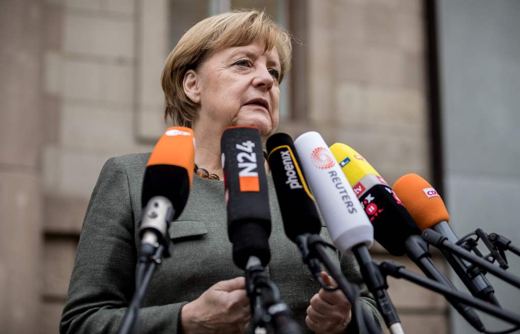 German Chancellor Angela Merkel, also leader of the conservative Christian Democratic Union (CDU) party, gives a statement as she arrives for further exploratory talks with members of potential coalition parties to form a new government on November 16, 20