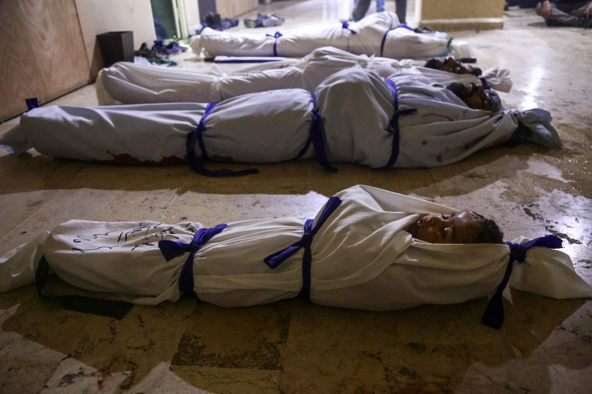 The bodies of Syrian children who died following reported shelling by Syrian government forces lie in a makeshift morgue in the rebel-held town of Douma in Syria's eastern Ghouta region, on November 17, 2017. AFP / Amer Almohibany
