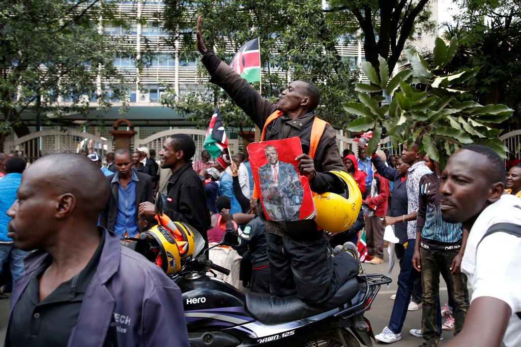Jubilee Party supporters celebrate after Kenya's Supreme Court upheld the re-election of President Uhuru Kenyatta in last month's repeat presidential vote, in Nairobi, Kenya November 20, 2017. REUTERS/Baz Ratner.