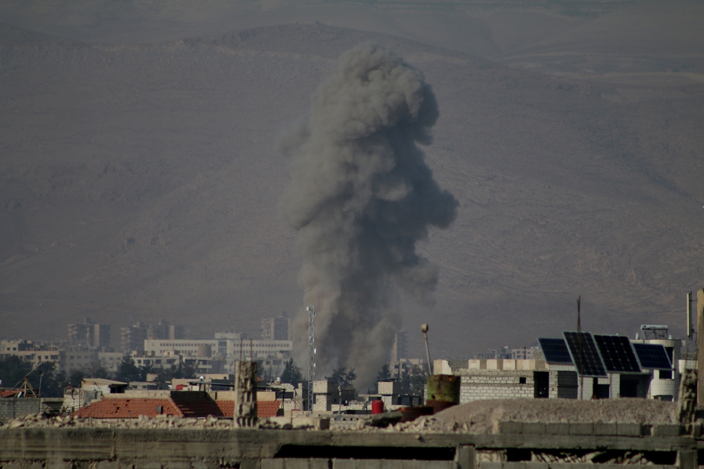 Smoke rises after Assad regime's war crafts carry out airstrikes over residential areas of Arbin town of the Eastern Ghouta region of Damascus in Syria on November 19, 2017. Samir Tatin - AA