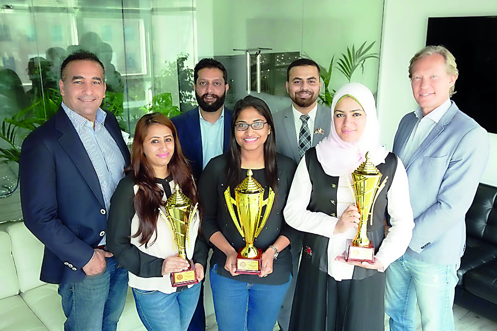 QPAY officials with the  awards it received at Middle East Cards and Payments Awards.