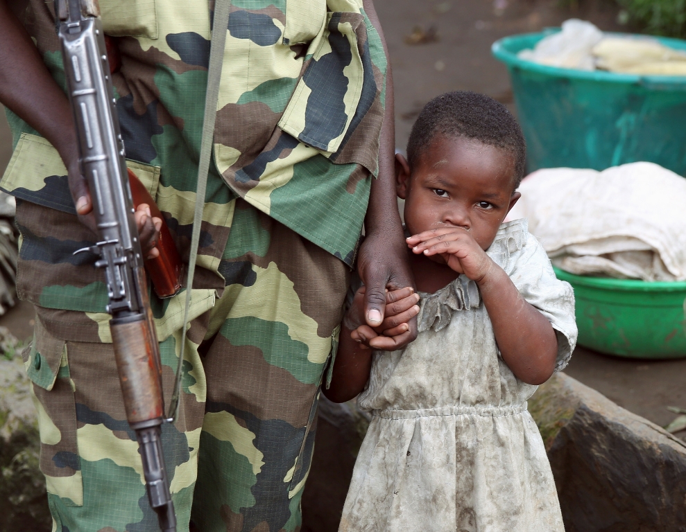 A file photo of a Congo girl holding a fighters hand. Reuters.