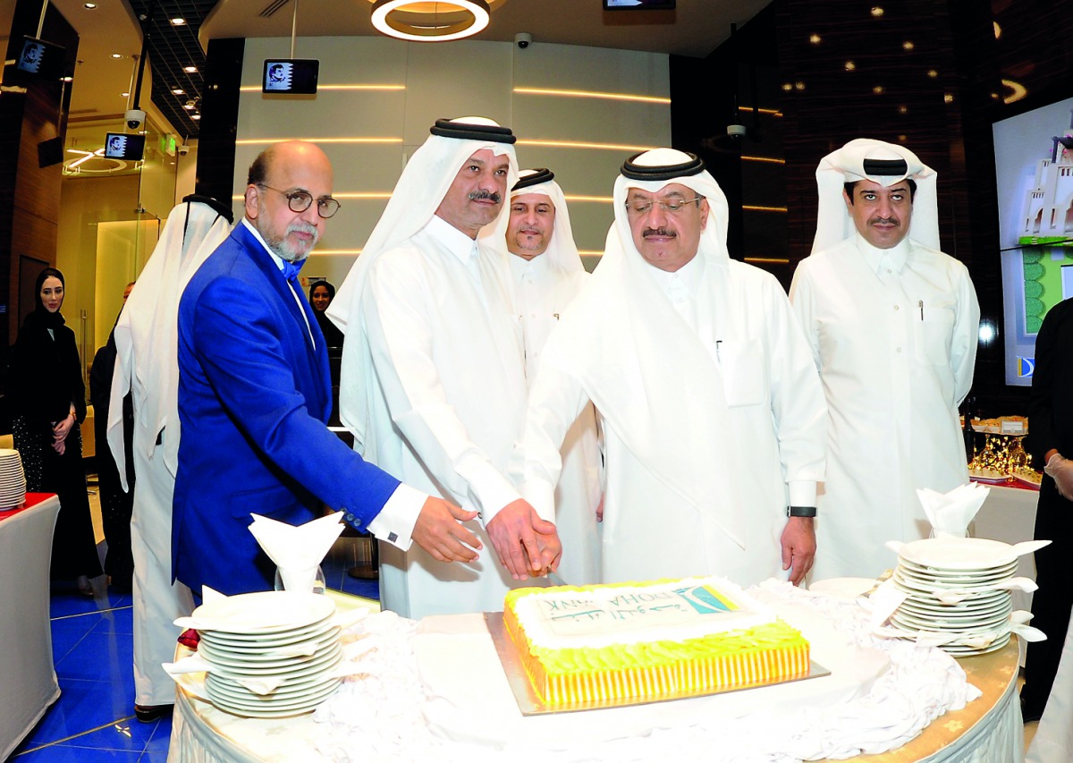 The officials of Doha Bank, Sheikh Fahad bin Mohammad bin Jabor Al Thani (second left), Chairman; Sheikh Abdul Rehman bin Mohammad bin Jabor Al Thani (second right), Managing Director; Dr R Seetharaman (left), Group CEO; jointly cutting a cake after the o